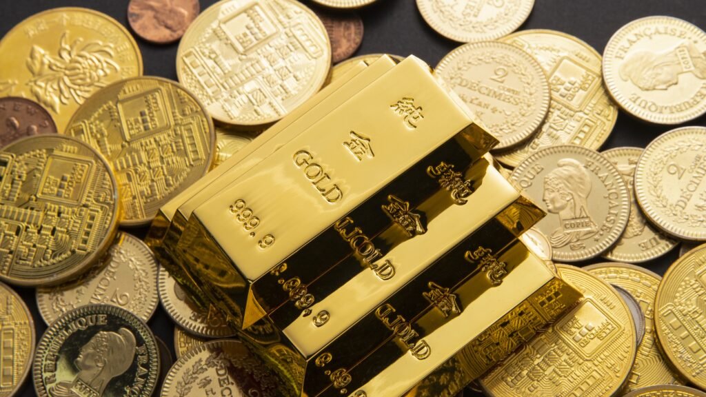 A closeup shot of a pile of shiny gold coins and bars